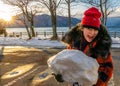 Young girl with giant snowball Royalty Free Stock Photo