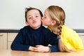 Young girl gives her brother a kiss