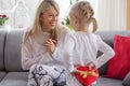 Young girl is giving present to her mother