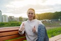 Young girl giving thumbs up sign of success. Portrait of a happy smiling strong man dressed in sports clothes. Focus on Royalty Free Stock Photo