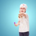 young girl with glasses plays in the doctor