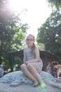 young girl with glasses plays on the playground, sunny day