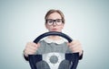 Young girl in glasses with steering wheel, auto concept Royalty Free Stock Photo