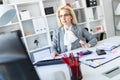 Young girl with glasses works in the office with documents, calculator and computer. Royalty Free Stock Photo