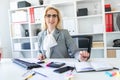 Young girl with glasses works in the office with documents, calculator and computer. Royalty Free Stock Photo