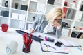 Young girl with glasses works in the office with documents, calculator and computer. Royalty Free Stock Photo