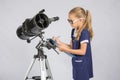 Young girl glasses writes astronomer observations