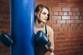 Young girl in gloves resting after a workout in the boxing gym Royalty Free Stock Photo