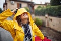 A young girl is in a good mood while walking and listening to the music on a rainy day. Walk, rain, city Royalty Free Stock Photo