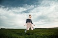 Young girl in a green field. Stylish girl. Green grass and blue sky. Emotional woman. plener. Travel. trip.