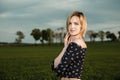 Young girl in a green field. Stylish girl. Green grass and blue sky. Emotional woman. plener. Travel. trip.