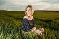 Young girl in a green field. Stylish girl. Green grass and blue sky. Emotional woman. plener. Travel. trip.