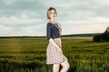 Young girl in a green field. Stylish girl. Green grass and blue sky. Emotional woman. plener. Travel. trip.