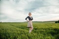 Young girl in a green field. Stylish girl. Green grass and blue sky. Emotional woman. plener. Travel. trip.