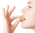 Young girl with a green pill Royalty Free Stock Photo
