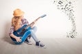 Young girl guitar play sitting on a floor Royalty Free Stock Photo