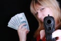 Young girl with gun and money Royalty Free Stock Photo