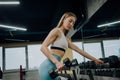 Young girl in the gym with dumbbells, Nice woman doing workout with dumbbells