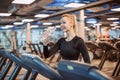 Young girl at the gym trainer holding a bottle of water. Portrait of beautiful young fit woman drinking water during Royalty Free Stock Photo