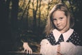 Small girl alone in wild forest in style of halloweeen witch Royalty Free Stock Photo