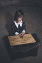 Small girl alone in old house in style of halloweeen witch Royalty Free Stock Photo