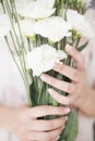 A young girl hand holding a large bouquet of fresh white flowers. Bright feminine lifestyle Royalty Free Stock Photo