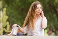 Young girl with a handbag talking on phone