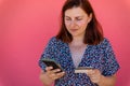 Young girl hands holding a credit card using mobile phone for online shopping on the street Royalty Free Stock Photo