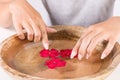 Young girl hands with natural manicure on finger nails and wooden bowl Royalty Free Stock Photo