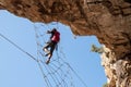 Via Ferrata - Girl Hanging on the Metal Net Royalty Free Stock Photo