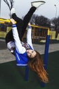 Young girl hanging upside down on the playground Royalty Free Stock Photo