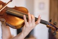 Young girl happily plays on her violin