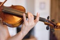 Young girl happily plays on her violin