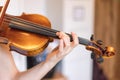 Young girl happily plays on her violin