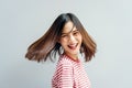 Young girl happy smile and cheerful in red dress in a swirling gesture and hair fluttering along the rotating force.