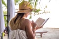 Girl reading a book on the beach Royalty Free Stock Photo