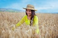 young girl in a hat in a wheat field Royalty Free Stock Photo