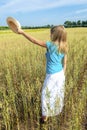 Young girl with hat in winter wheat field Royalty Free Stock Photo