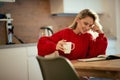 A young girl having a cigarette and a coffee while studies at the kitchen. Routine, student, morning Royalty Free Stock Photo