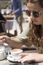 Young girl having a coffee on a sunny spring day Royalty Free Stock Photo