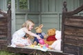 Young girl having doll's tea party