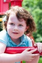 Young girl having fun outside at park on a playground swing set Royalty Free Stock Photo