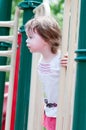 Young girl having fun outside at park on a playground swing set Royalty Free Stock Photo