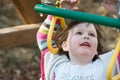 Young girl having fun outside at park on a playground swing set Royalty Free Stock Photo