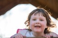 Young girl having fun outside at park on a playground swing set Royalty Free Stock Photo