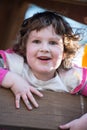 Young girl having fun outside at park on a playground swing set Royalty Free Stock Photo