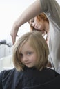 A young girl having her hair cut in the hairdressers