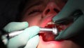 Young girl having her teeth fixed at the dentist's.