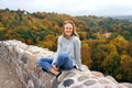 Young girl having a walk in Autumn forest. Beautiful park with dry yellow and red leaves and colorful trees Royalty Free Stock Photo