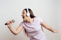 Young girl in headphones expressively sings Royalty Free Stock Photo